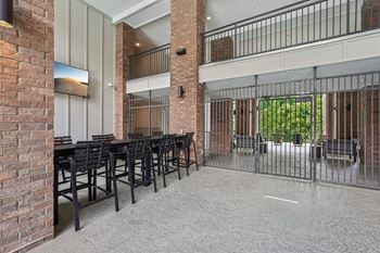 outdoor dining table area with flat-screen TVs